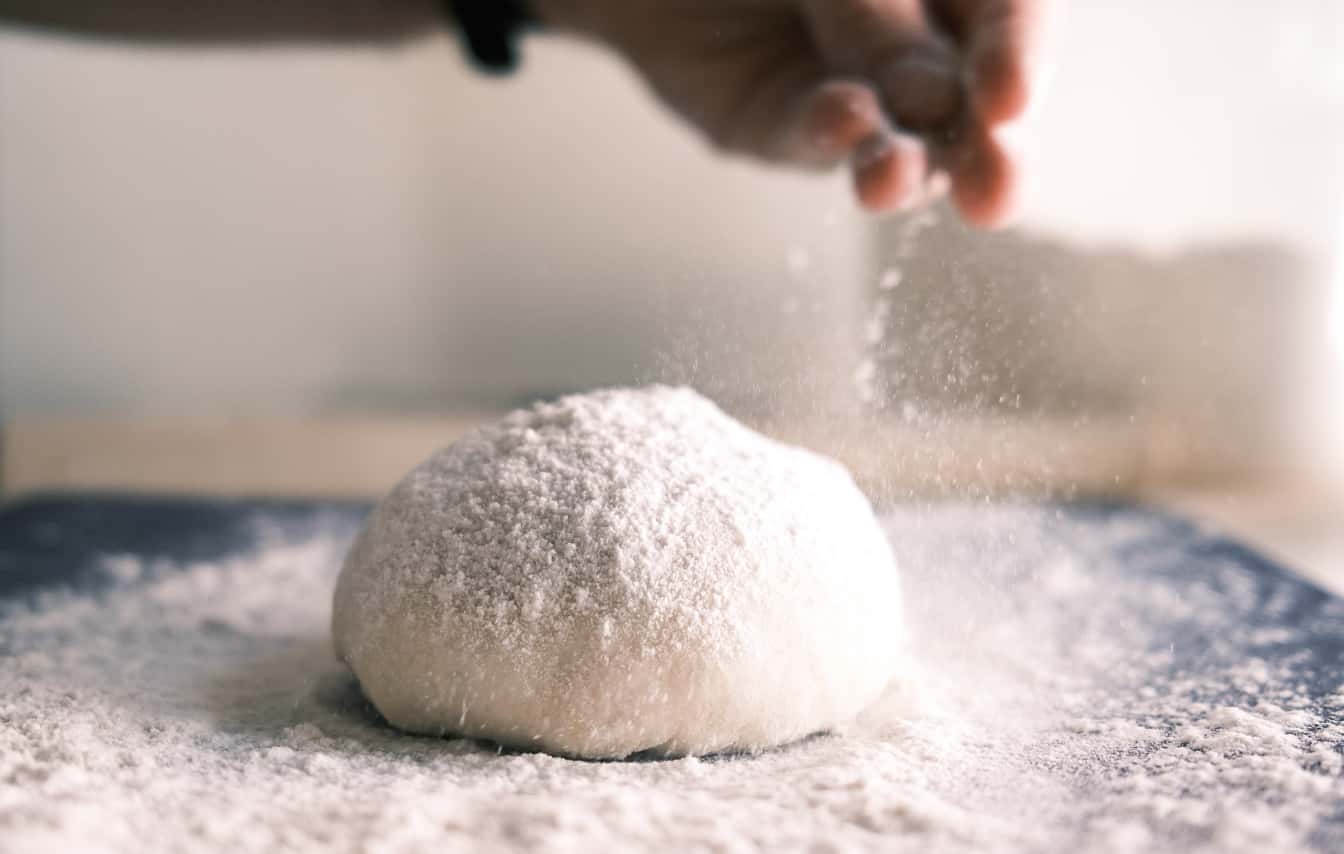 Photo of a dough ball sprinkled with flour.
